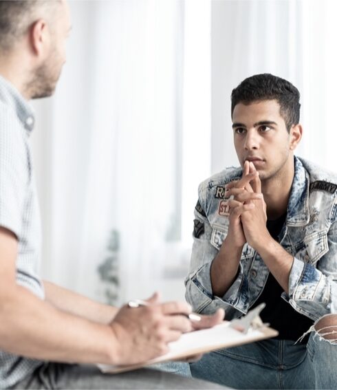 Therapist speaking with a young man