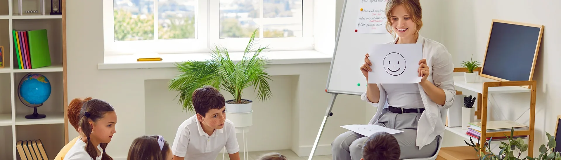 A teacher supporting a group of children on the topic of mental health.
