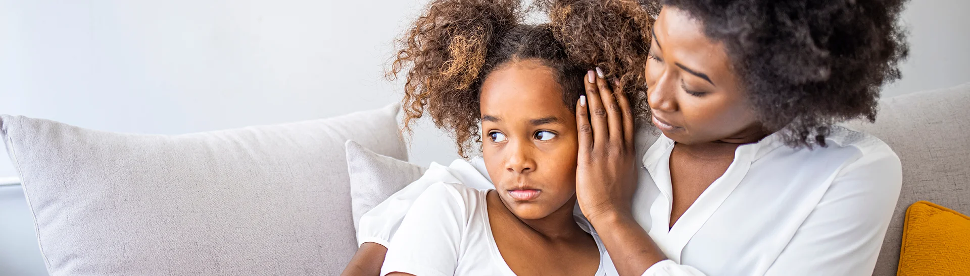 Upset child being comforted by mother