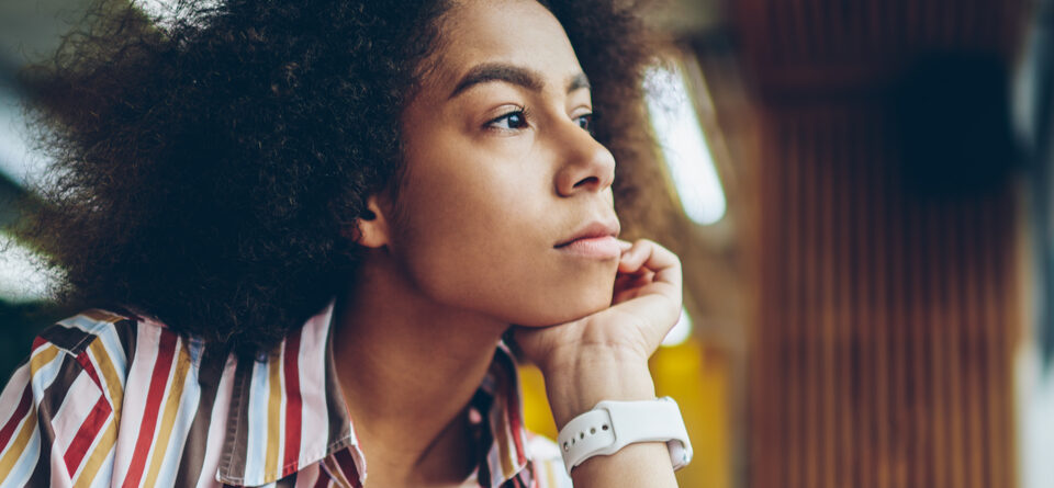 Pondering African-American young woman thinking