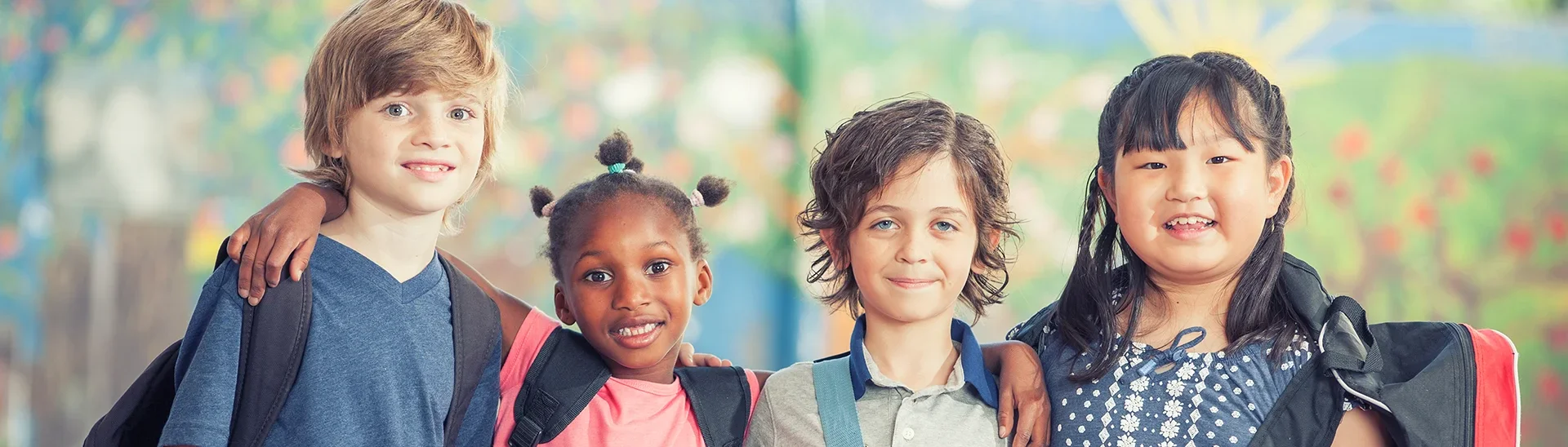 Diversegroupofchildrensmilingtogetheratschool