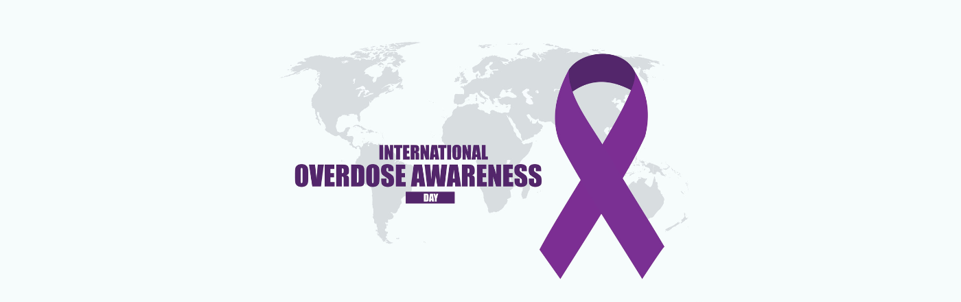 International Overdose Awareness Day is written in purple over a world map next to a purple ribbon.