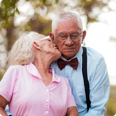eldery-married-couple Elderly couple. Wife kissed husbands cheek