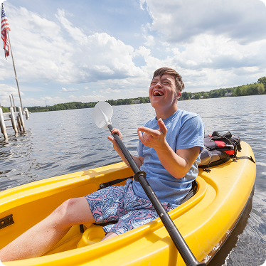 young-boy-kayaking Young boy kayaking in yellow kayak
