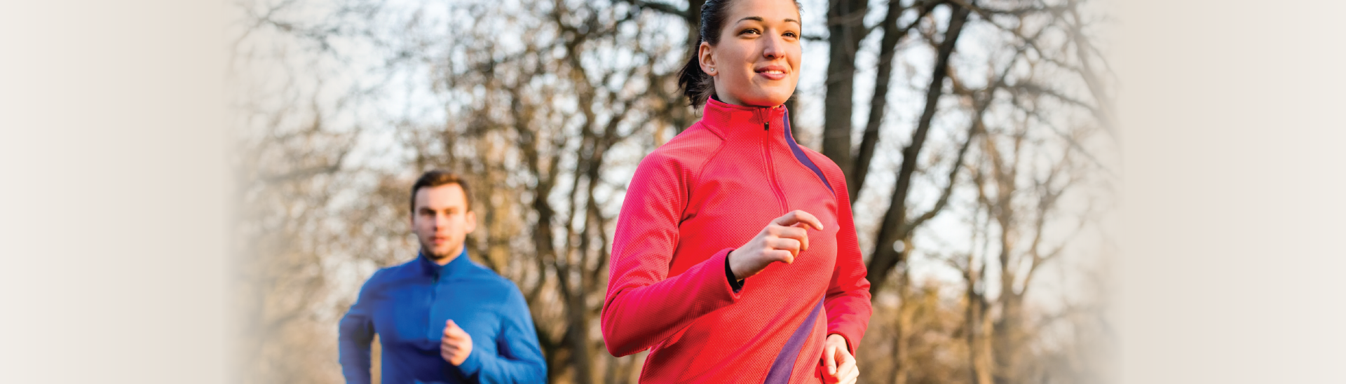 Heart heath month showing a man and woman running together in the woods.
