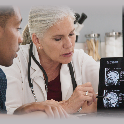 Brain_Injury_Awareness_banner_500x500_20260226 A doctor reviews a brain scan with a patient to explain his condition.