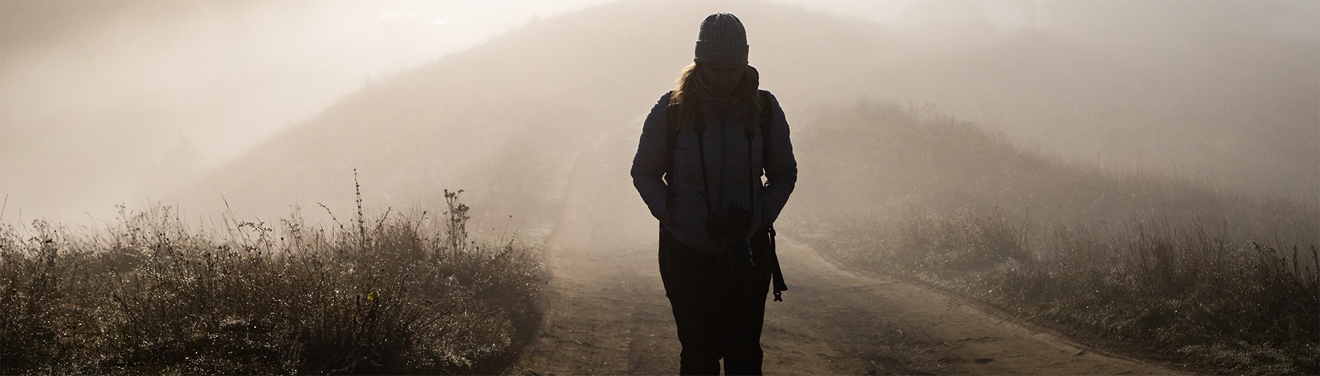 PTSD Awareness month - woman walking alone on the road