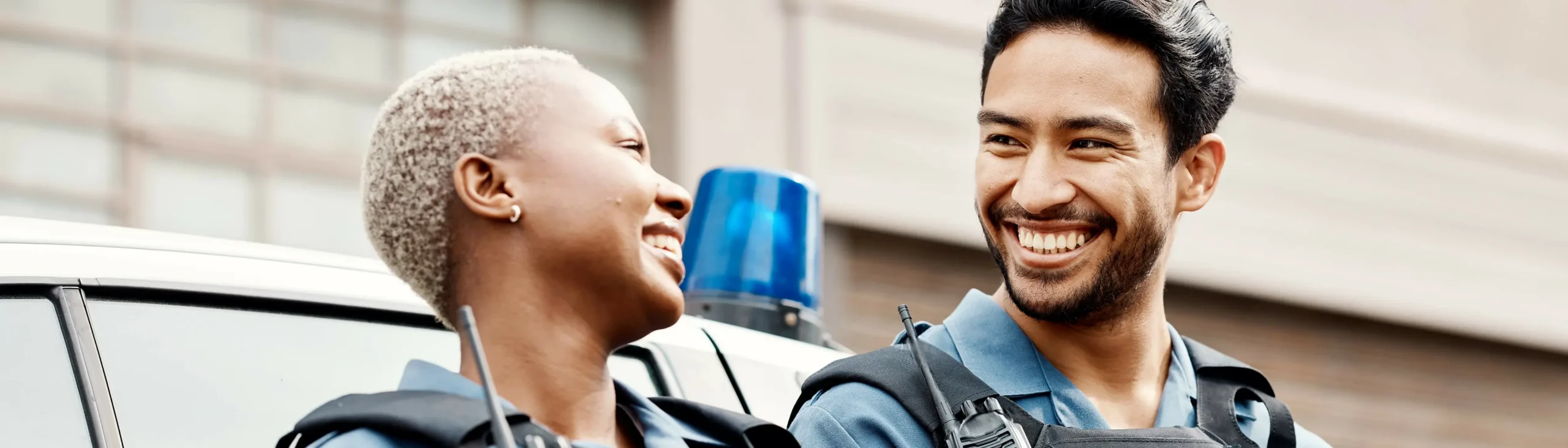 Two police officers smiling together.